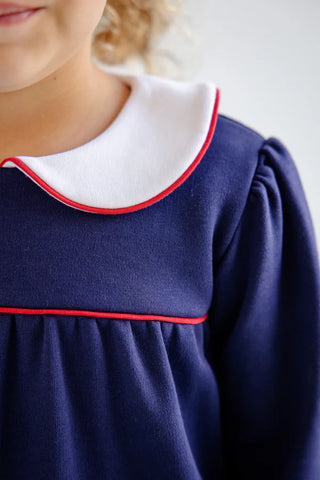 Close-up of Maerin Fritz Frock collar in white with red piping detail on navy fabric by The Beaufort Bonnet Company.