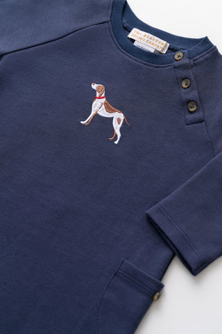 Close-up of Rayburn Romper in Nantucket Navy featuring embroidered dog detail and shoulder snap closures by TBBC
