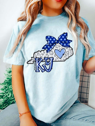 Kentucky Leopard Doodle Tee—light blue shirt with KY leopard print state, polka dot bow, heart, and bold Wildcat-themed state pride design.