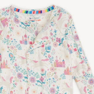 Close up of Magnetic Me Tail of Magic Convertible Coverall with pastel unicorn and castle print, and magnetic closures .