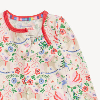 Close-up of Magnetic Me Sugar Plum Dreams sleeper showing detailed woodland holiday print, soft modal fabric, and red neckline trim.