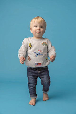 Boys gray sweatshirt with playful patches—features dinos, trucks, planes, football, and more for everyday adventure.