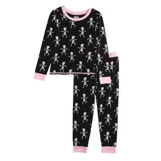 Girls glow-in-the-dark Halloween pajamas with pink skeleton print—cozy bamboo sleep set perfect for spooky season fun.