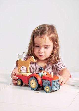 Wooden farm tractor playset with trailer, farmer figure, hay bales, horse, and goose—perfect for pretend play and farm adventures.