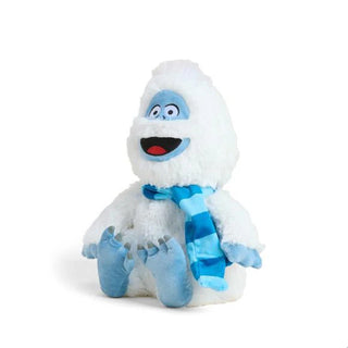 Side view of Warmies Bumble plush smiling with bright blue striped scarf and soft blue paws for a festive winter look.