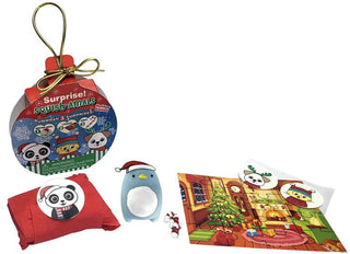Unwrapped Zorbitz Squish Amal Christmas Ornament showing squishy penguin toy with Santa hat, mini puzzle, and surprise gift packaging.