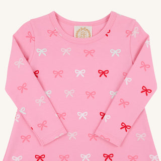 Close-up flat lay of the Pink Long Sleeve Polly Play Dress with pink, white, and red Bitty Bows print, perfect for everyday wear.