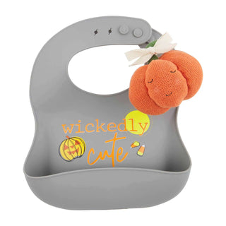 Gray silicone Halloween bib with "Wickedly Cute" text and a pumpkin-shaped rattle—festive and functional for baby’s spooky season.