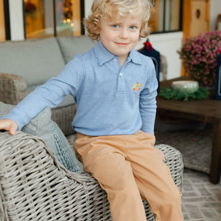Smiling boy in Bailey Boys turkey embroidered royal microstripe long sleeve polo shirt, perfect for Thanksgiving.