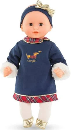 Standing holiday Corolle doll wearing navy dress with plaid accents, white tights, gold shoes, and matching gold bow headband.