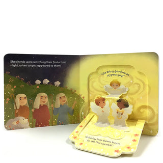Inside pages of The First Christmas Lift-A-Flap Book with angels announcing Jesus’ birth to shepherds in interactive pop-up style