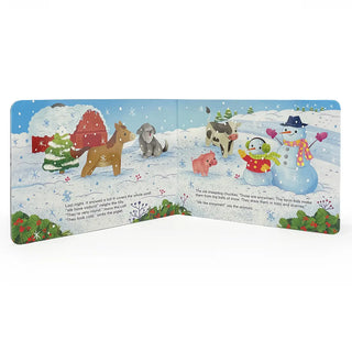 Inside spread of First Christmas on the Farm from Cottage Door Press with farm animals and children building snowmen in a snowy yard