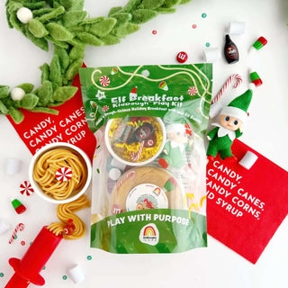 Elf Breakfast KidDough Play Kit with candy canes, syrup bottle, dough noodles, and holiday toppings for festive sensory fun.