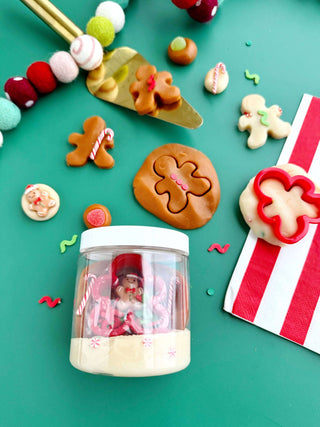 Mini Gingerbread Dough Jar with cookie cutter, candy pieces, and gingerbread figures for festive holiday sensory play.