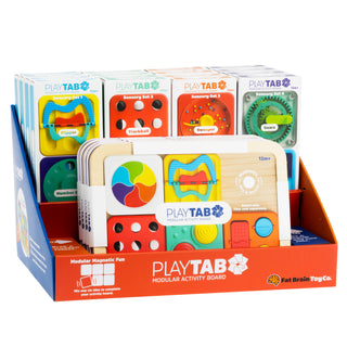 Fat Brain Play Tab board and tiles in retail display showing full modular activity board and multiple sensory sets in packaging.