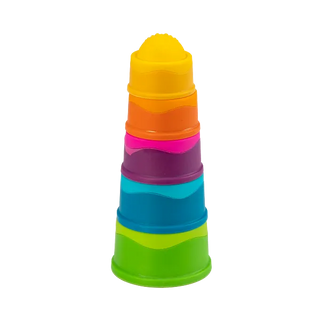 Tower of Dimpl Stack cups fully stacked from largest green base to smallest yellow top, each with textured silicone bubbles.