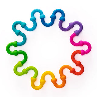 Plip Links arranged in a full rainbow circle on white background, showing all 10 vibrant ball-and-socket link pairs connected together.