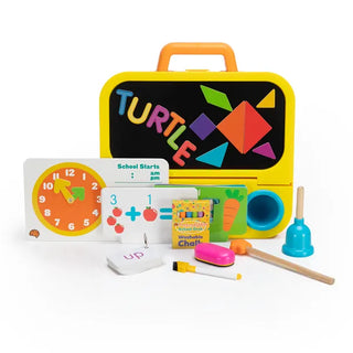 Pretendables School Desk displayed with “TURTLE” spelled out, math flashcards, tangram board, chalk, and learning accessories.
