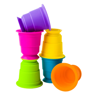 Set of six rainbow silicone Suction Kupz stacked and balanced together, showing vibrant colors and squishy, flexible texture. 