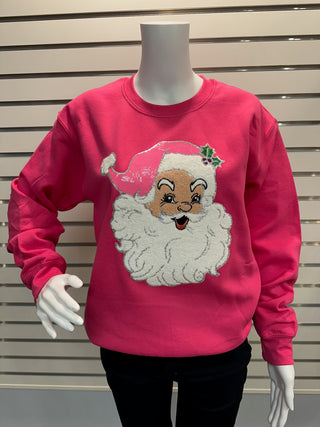 Full mannequin view wearing hot pink chenille Santa sweatshirt paired with black pants, highlighting festive vintage-style Santa patch.
