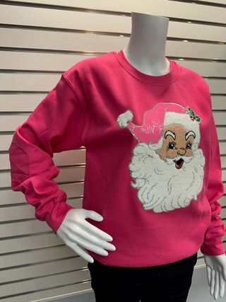 Front view of hot pink sweatshirt on mannequin showcasing chenille Santa patch with textured beard and sequin-trimmed pink hat.
