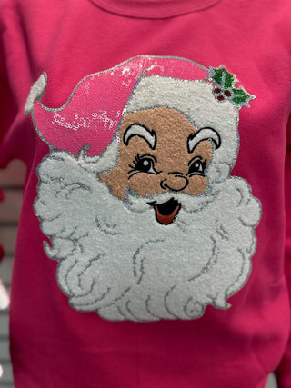 Close-up of chenille Santa patch on hot pink sweatshirt showing textured beard, sparkly accents, and detailed vintage-inspired Santa face.