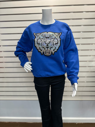 Full mannequin view wearing royal blue sequin UK Wildcat sweatshirt paired with black pants for a game-day ready look.