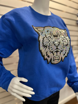 Side view of women’s royal blue sequin UK Wildcat sweatshirt showing bright color and detailed wildcat patch on mannequin.