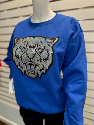 Women’s royal blue sweatshirt on mannequin featuring large sparkling sequin UK Wildcat patch with bold detailing.