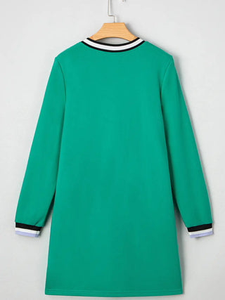 Back view of green V-neck varsity dress with long sleeves, striped neckline, and cuff details hanging on a wooden hanger.