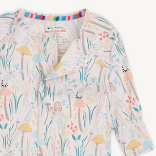 Close-up of Magnetic Me Shroom and Bloom Modal Convertible Coverall showing woodland print and magnetic closure details.