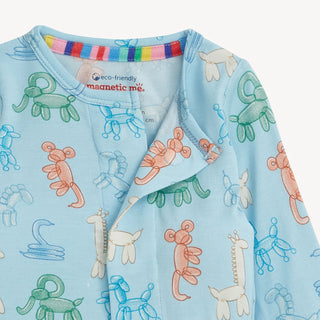 Close-up photo of the Magnetic Me Blue Party Animals coverall, showing the magnetic fasteners, eco-friendly tag, and the detailed balloon animal print.