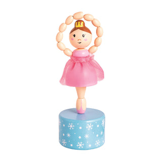 Brunette ballerina in a pink dress and gold crown, standing on a blue snowflake base from Mud Pie’s collapsible toy series.