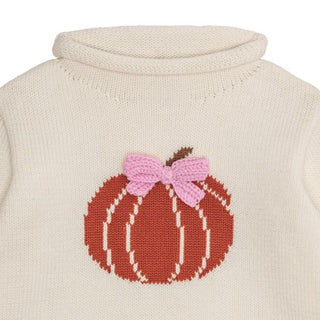 Ivory girls’ rollneck sweater with pumpkin intarsia and pink bow—perfect for fall photos, pumpkin patches, and Thanksgiving gatherings.
