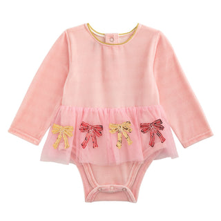Pink velour baby crawler with long sleeves, mesh tutu, and sequin bow appliqués—perfect for festive photos and cozy holiday moments.