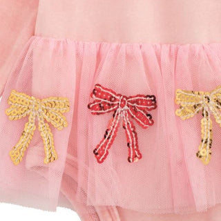 Pink velour baby crawler with long sleeves, mesh tutu, and sequin bow appliqués—perfect for festive photos and cozy holiday moments.