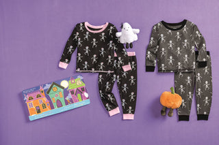 Matching girls and boys glow-in-the-dark skeleton pajamas—spooky-soft Halloween sets perfect for sibling photo ops and trick-or-treating.