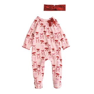Pink baby sleeper with red and pink bow print, velour bow accent, and matching headband—perfect for baby girl’s first Christmas.