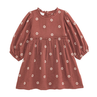 Rust-colored cotton gauze dress with embroidered white daisies, ruffled neck, and long sleeves—perfect for fall outings and photos.