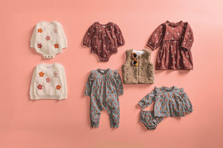 Rust-colored cotton gauze dress with embroidered white daisies, ruffled neck, and long sleeves—perfect for fall outings and photos.