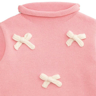 Pink cotton rollneck sweater for girls featuring six cream crochet bows—classic boutique charm with cozy fall and winter style.