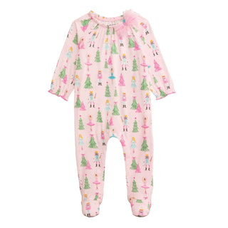 Pink bamboo baby sleeper with Nutcracker print and mesh bow—soft, festive, and footed for cozy holiday nights.