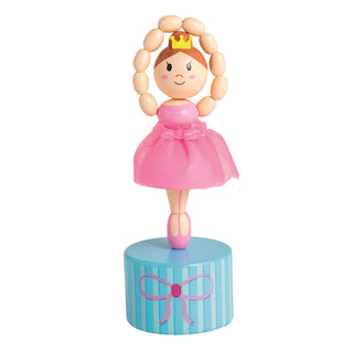 Wooden toy figure of a ballerina in a pink dress on a blue cylindrical stand with a pink bow, on a white background.