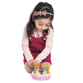 Wooden birthday cake toy with rainbow slices, candles, and slicer—perfect for pretend play and learning through celebration.