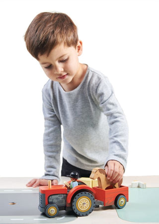Wooden farm tractor playset with trailer, farmer figure, hay bales, horse, and goose—perfect for pretend play and farm adventures.