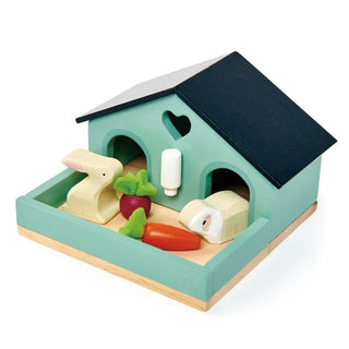 Wooden bunny hutch playset with rabbit, guinea pig, felt veggies, and water bottle—perfect for pretend pet care and nurturing play.