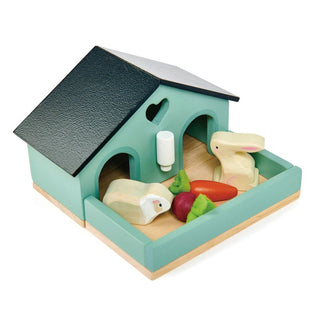Wooden bunny hutch playset with rabbit, guinea pig, felt veggies, and water bottle—perfect for pretend pet care and nurturing play.