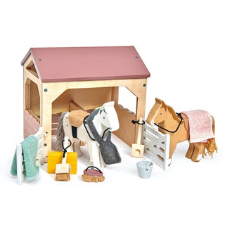 Wooden horse stable playset with ponies, grooming tools, saddle blankets, and barn accessories—perfect for little horse lovers.