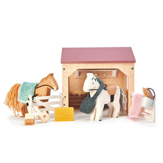 Wooden horse stable playset with ponies, grooming tools, saddle blankets, and barn accessories—perfect for little horse lovers.