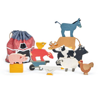 Stackable wooden farm animals set with barn bag—includes 10 animals, hay bale, and wheelbarrow for open-ended, screen-free play.